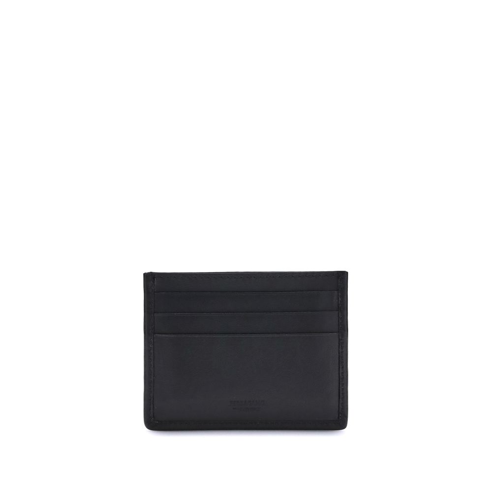Black Calf Leather Bos Taurus WalletThe Ferragamo Gancini Card Holder combines elegance and craftsmanship in a compact and refined format. Featuring slots on both sides for practical organization, it is embellished with a palladium-finish Gancini ornament