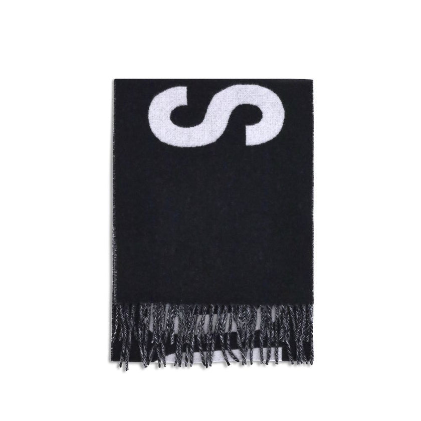 Fringes wool ScarfThe Jacquemus Wool Scarf is an essential accessory with a modern and minimal style. Made of solid-colored yarn, it is embellished with a contrasting jacquard logo, which gives character without sacrificing sobriety. The design is complet