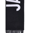 Fringes wool ScarfThe Jacquemus Wool Scarf is an essential accessory with a modern and minimal style. Made of solid-colored yarn, it is embellished with a contrasting jacquard logo, which gives character without sacrificing sobriety. The design is complet