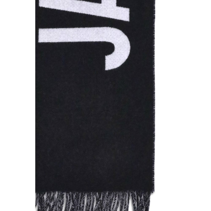 Fringes wool ScarfThe Jacquemus Wool Scarf is an essential accessory with a modern and minimal style. Made of solid-colored yarn, it is embellished with a contrasting jacquard logo, which gives character without sacrificing sobriety. The design is complet