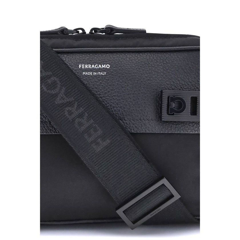 Black Calf Leather Bos Taurus Shoulder BagThe Ferragamo Gancini buckle Shoulder Bag combines style and functionality with a mix of technical fabric and hammered leather. The roomy interior with zip and a back pocket make it practical, while the patent-fin