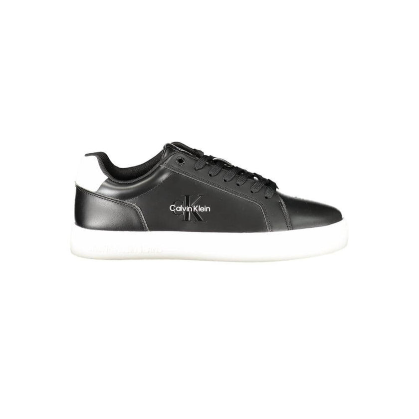 Black Leather Men SneakerStep up your game with the Calvin Klein sports shoe, where function meets fashion in a dynamic fusion. Featuring a sleek black design punctuated by bold, contrasting white details, these sneakers boast both style and substance. Th