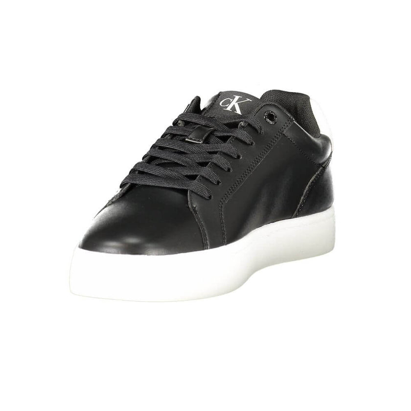 Black Leather Men SneakerStep up your game with the Calvin Klein sports shoe, where function meets fashion in a dynamic fusion. Featuring a sleek black design punctuated by bold, contrasting white details, these sneakers boast both style and substance. Th