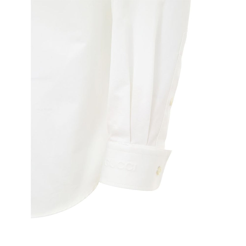 White Cotton Dress ShirtGucci Double Collar Cotton Poplin Shirt. Front button fastening, removable classic shirt collar, mandarin collar. Double cuff. Patch pocket on the side, rounded at the bottom. Composition: 100% Cotton Internal SKU: 25GIU202 Brand S