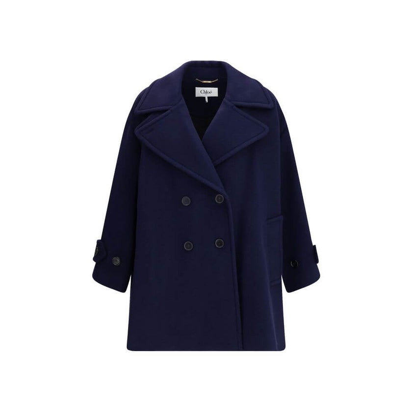 Blue Wool CoatThe Chloé oversized double breasted Wool Coat is a sleek, structured piece for the cold season. Featuring wide lapels and a collar strap, it is finished with engraved horn buttons at the collar, front and cuffs. Side pockets and a knee-lengt