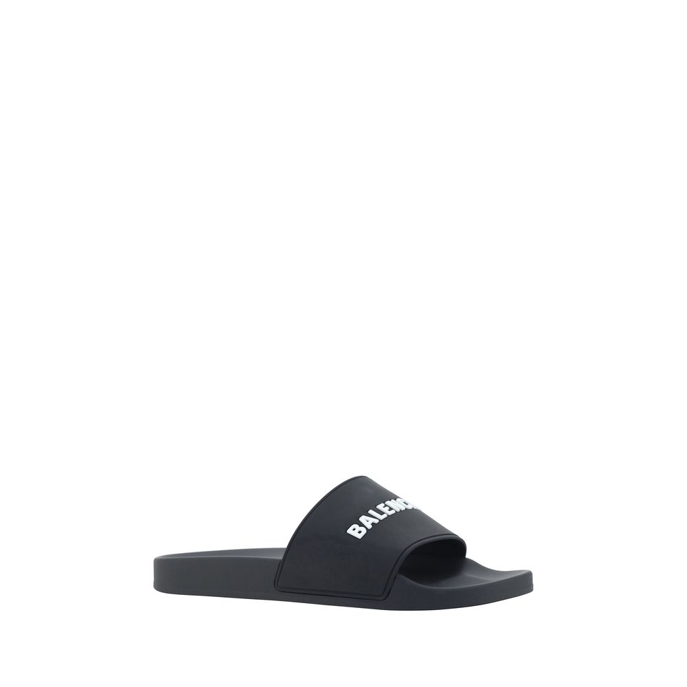 Black Rubber Flat SandalsBalenciaga’s Rubber Pool Sandals are a slip-on style with a minimal and contemporary style. Featuring a flat sole for maximum comfort, they feature the brand’s iconic contrasting signature on the front strap, which adds a distinct