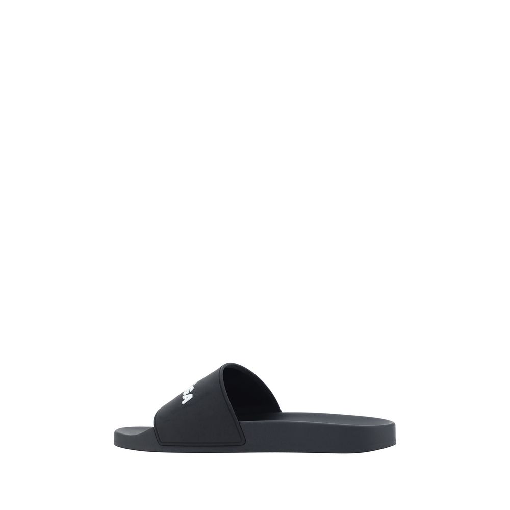 Black Rubber Flat SandalsBalenciaga’s Rubber Pool Sandals are a slip-on style with a minimal and contemporary style. Featuring a flat sole for maximum comfort, they feature the brand’s iconic contrasting signature on the front strap, which adds a distinct