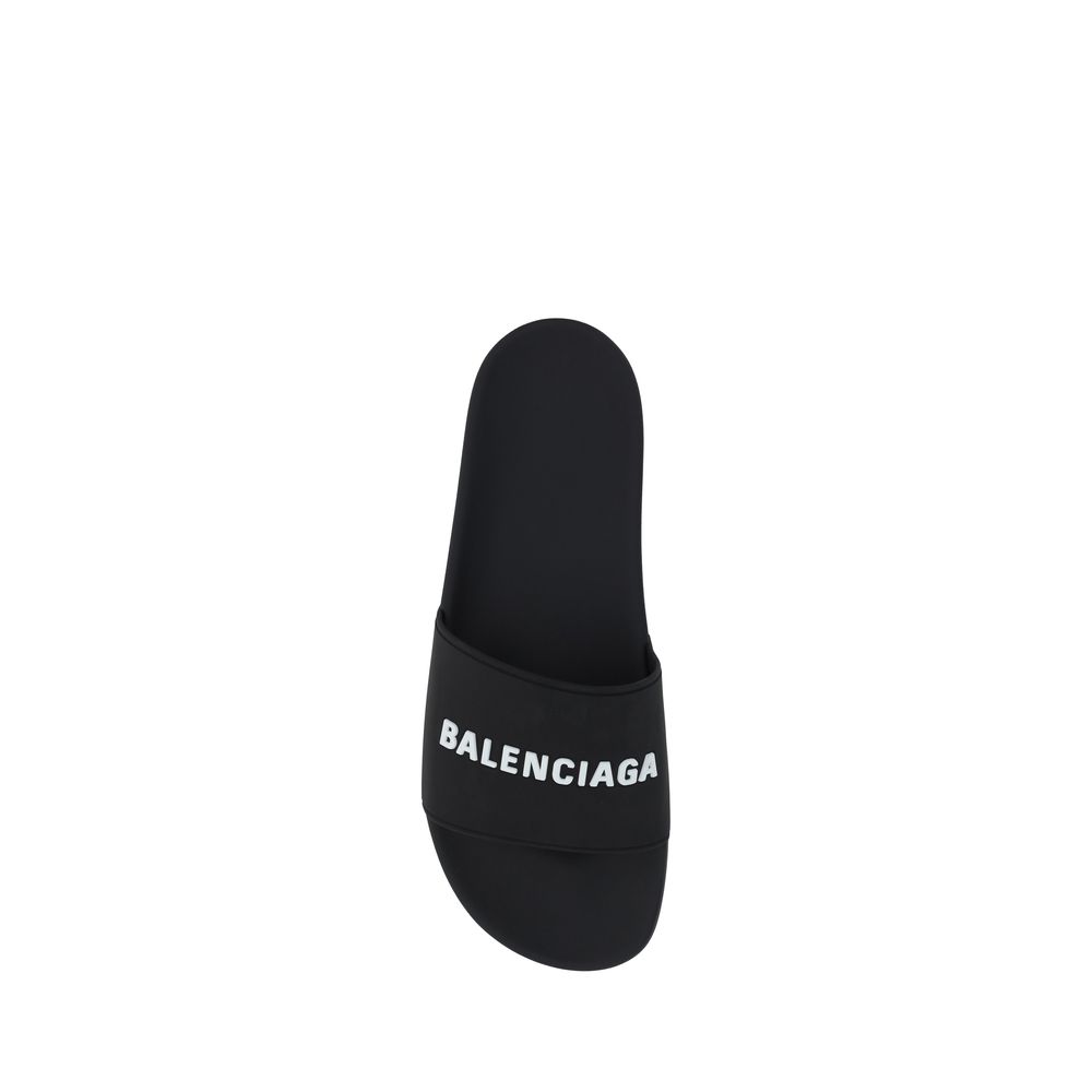 Black Rubber Flat SandalsBalenciaga’s Rubber Pool Sandals are a slip-on style with a minimal and contemporary style. Featuring a flat sole for maximum comfort, they feature the brand’s iconic contrasting signature on the front strap, which adds a distinct