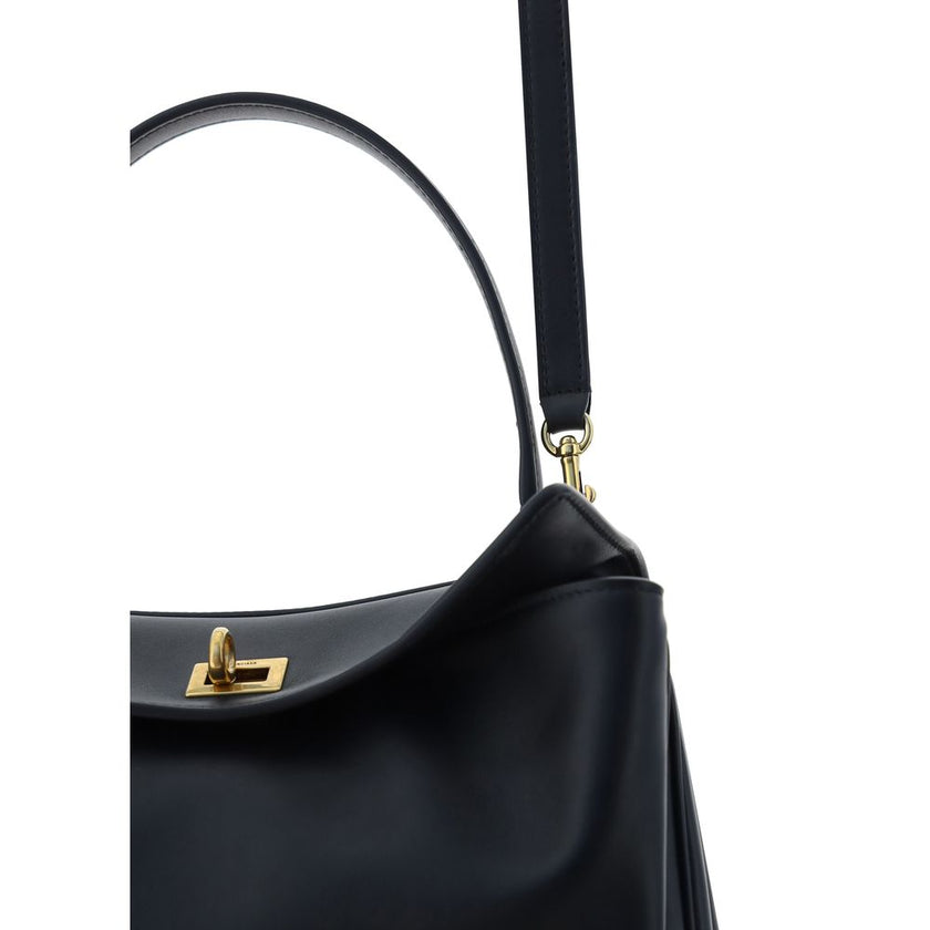 Black Calf Leather Bos Taurus Shoulder BagBalenciaga’s signature leather Rodeo Shoulder Bag is a sophisticated and versatile accessory. The flat handle at the top offers a comfortable grip, while the removable shoulder strap allows you to adapt it to your