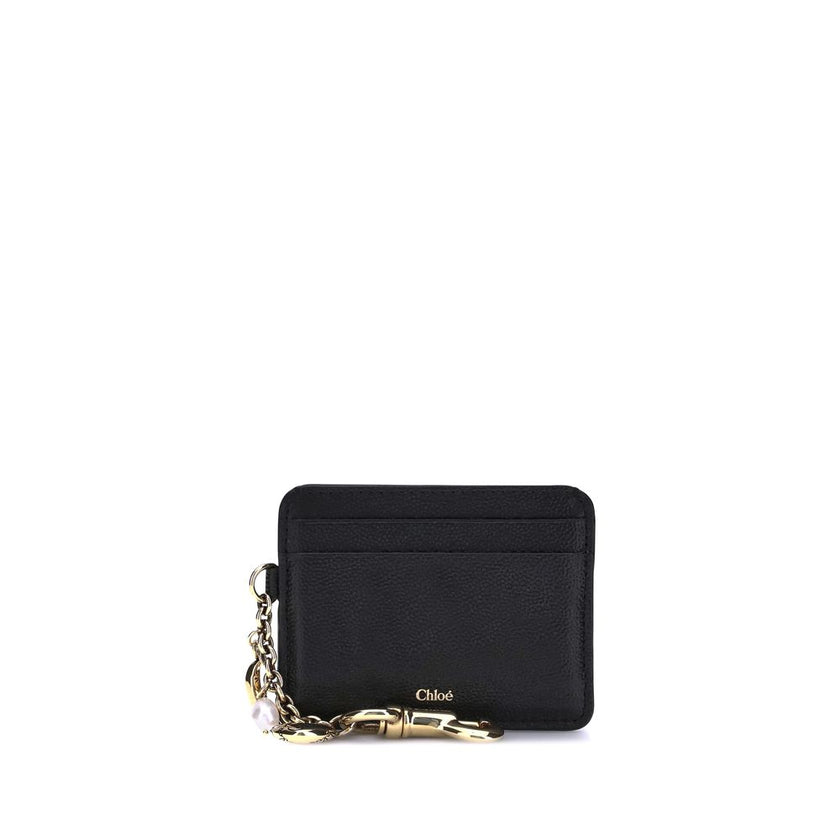 Black Calf Leather Bos Taurus WalletThe Charms Card Holder by Chloé is a compact and refined accessory, crafted from grained and shiny calfskin. Its classic silhouette houses one main compartment and four card slots, offering practicality without sacrific