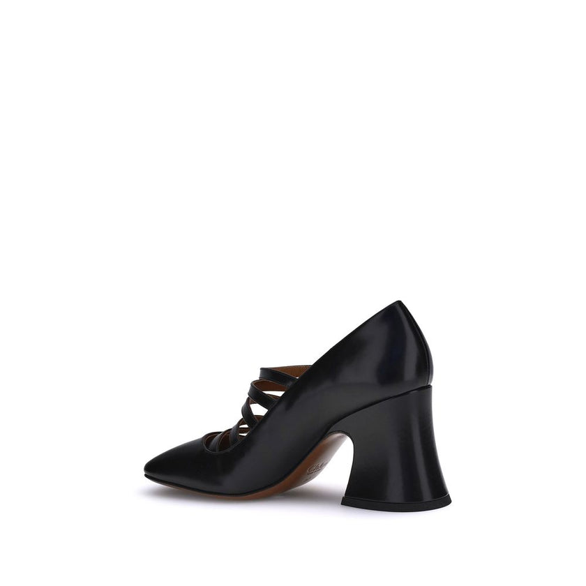 Black Calf Leather Bos Taurus High Heel PumpsThe Janis Pumps by Chloé are crafted from shiny calfskin and feature a bell-shaped block heel and slightly squared toe. The adjustable straps, embellished with gold buckles engraved with the Chloé logo, add a r