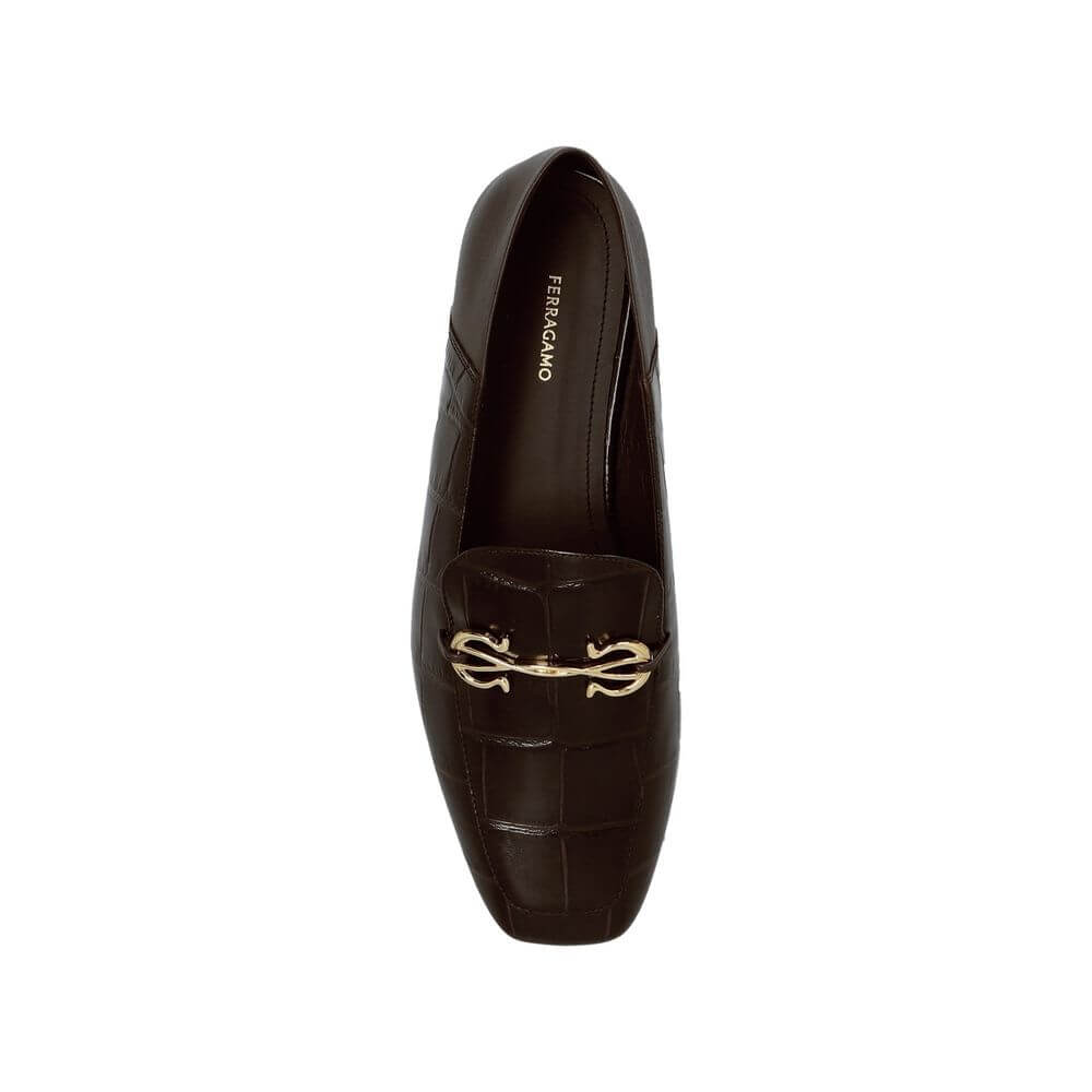 Brown Calfskin Slip-On LoafersDescription: – Composition: 100% calf leather – Inner: Leather – Insole: Leather – Sole: Leather – Branded insole – Slip-on design – Sole Height at the highest point: 1,5cm – Embossed to mimic crocodile skin – Decorative gold