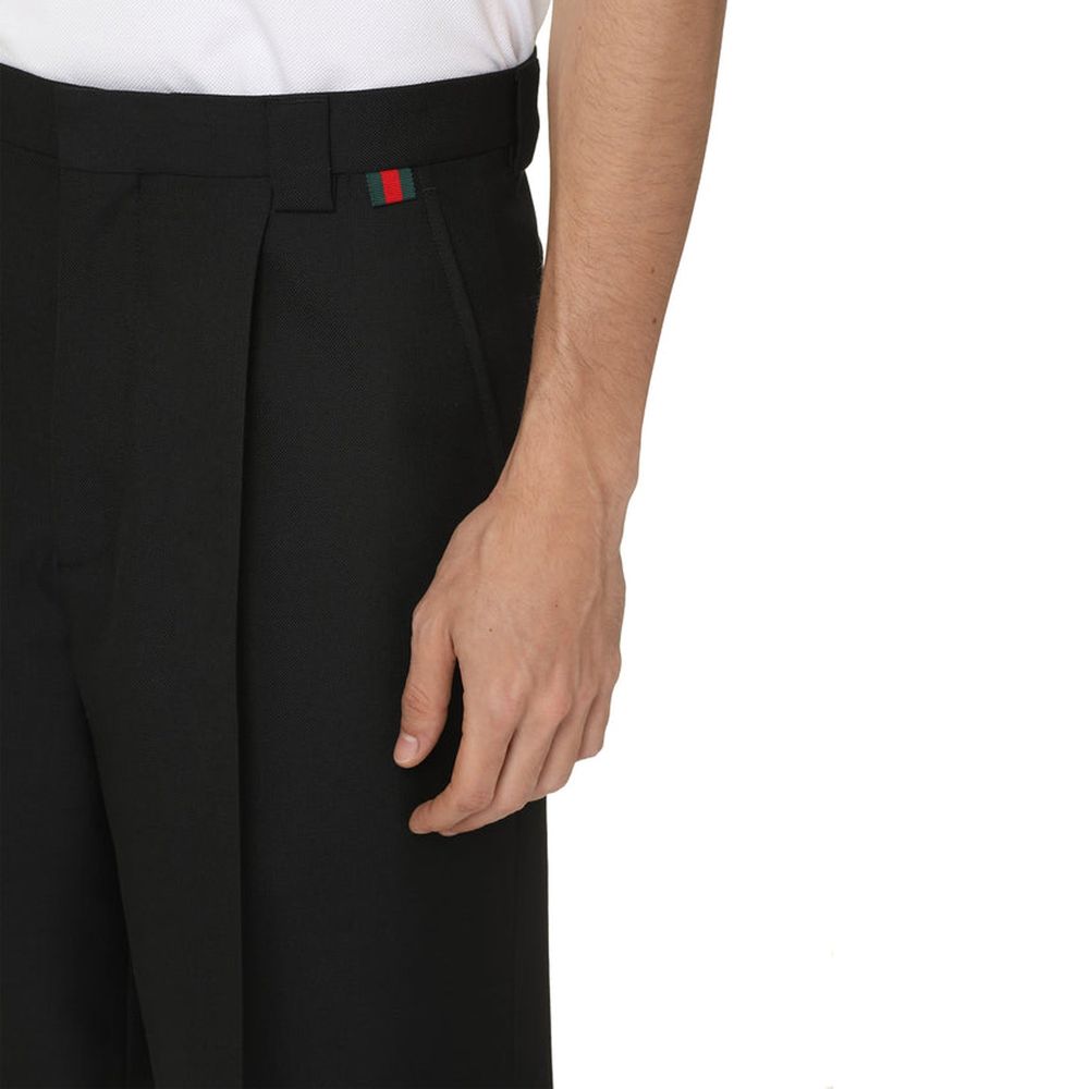 Black Polyester Bermuda ShortsDescription: – Composition: 55% Polyester 45% Wool – Two side pockets – Dry clean – Belt loops – Zip and hook & eye closure – Two back welt pockets – Distinctive green-red-green web detail – Made in Italy – Gender: MEN – Size