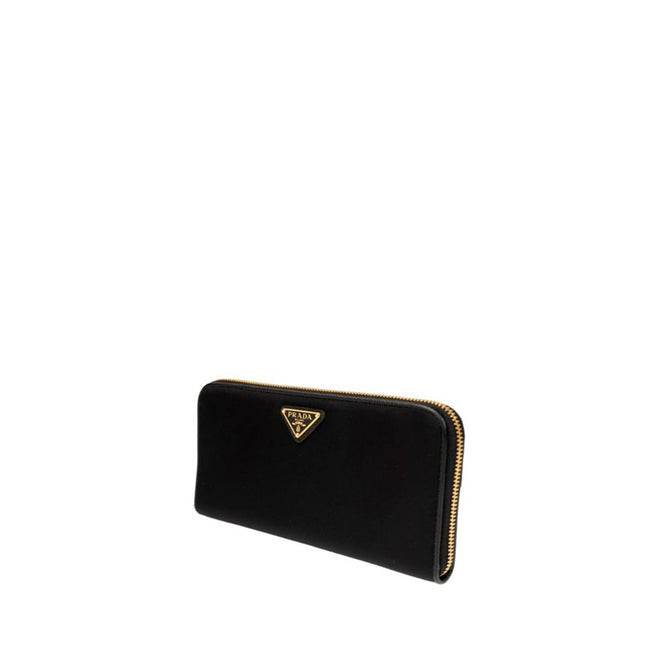 Black Nylon WalletDescription: – Composition: 100% Nylon – Lining: Leather – Top zip closure – Internal card slots – Length 20 cm – Width 2,5 cm – Two compartments – Front enamelled metal triangle logo – Height 11 cm – Made in Turkey – Gender: WOMEN –Blac