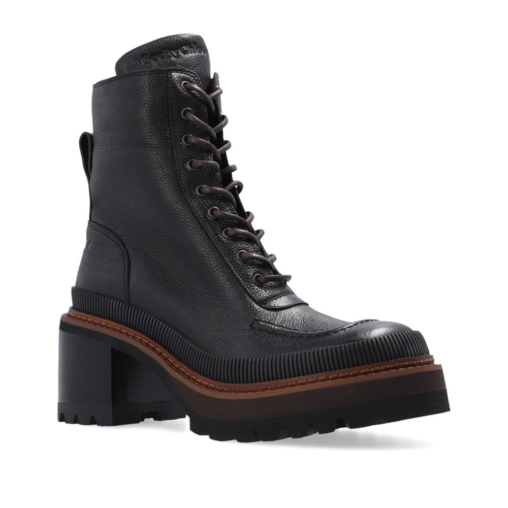 Black Calfskin Lace-Up BootsDescription: – Composition: 100% calf leather – Leather lining and insole – Rubber sole – Textured black leather – Lace-up fastening – Side zip fastening – Back logo detail – Heel 7 cm / 2,75 in – Made in Spain –Black Calfskin