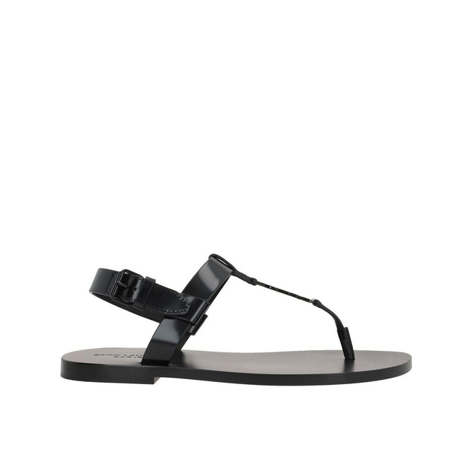 Black Calfskin Flat SandalsDescription: – Composition: 100% calf leather – Inner: Leather – Insole: Leather – Sole: Leather – Round toe – Patent effect – Adjustable buckle closure – Thong strap – Cassandre logo in enamelled metal – Made in Italy – Gender: