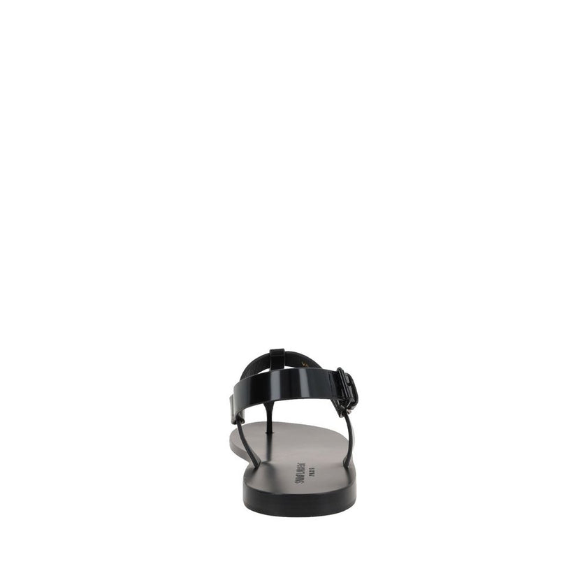 Black Calfskin Flat SandalsDescription: – Composition: 100% calf leather – Inner: Leather – Insole: Leather – Sole: Leather – Round toe – Patent effect – Adjustable buckle closure – Thong strap – Cassandre logo in enamelled metal – Made in Italy – Gender: