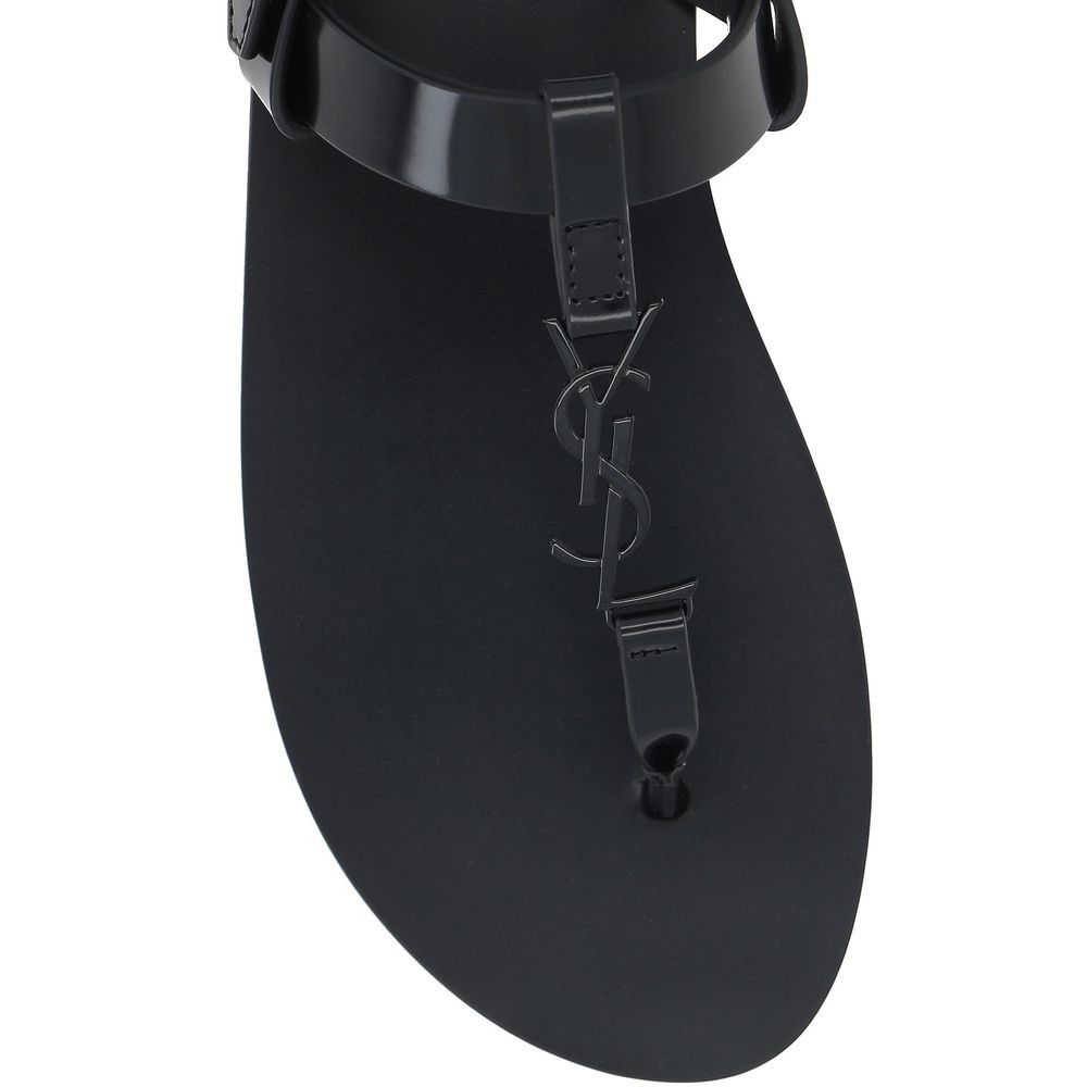 Black Calfskin Flat SandalsDescription: – Composition: 100% calf leather – Inner: Leather – Insole: Leather – Sole: Leather – Round toe – Patent effect – Adjustable buckle closure – Thong strap – Cassandre logo in enamelled metal – Made in Italy – Gender: