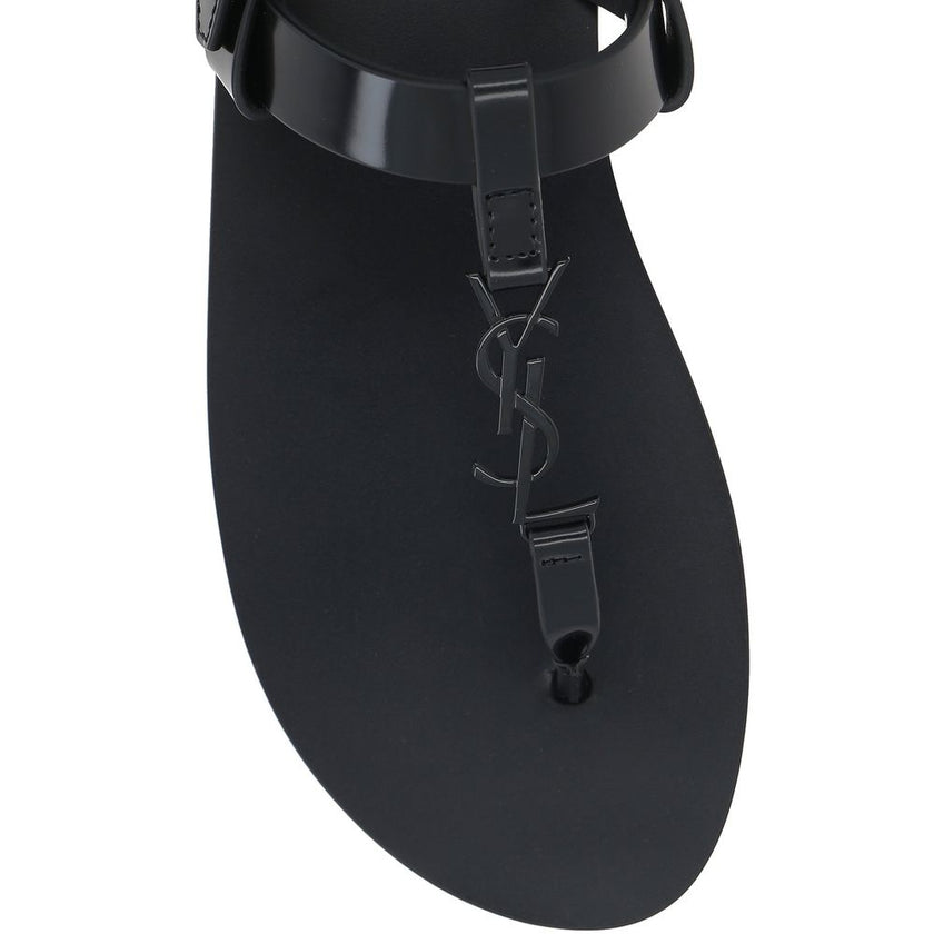 Black Calfskin Flat SandalsDescription: – Composition: 100% calf leather – Inner: Leather – Insole: Leather – Sole: Leather – Round toe – Patent effect – Adjustable buckle closure – Thong strap – Cassandre logo in enamelled metal – Made in Italy – Gender: