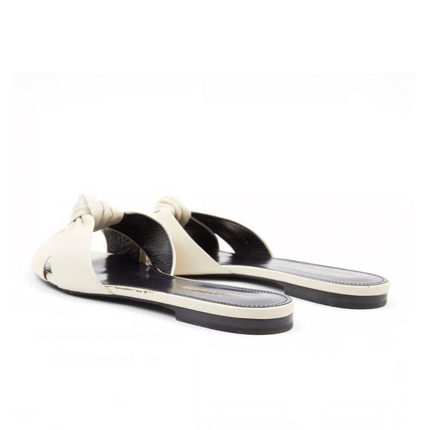 White Calfskin SlidesDescription: – Composition: 100% calf leather – leather insole and sole – open back – open toe – round toe – branded insole – made in Italy –White Calfskin Slides${tagsSaint LaurentAulae Leather Slides Saint LaurentAulae Leather Slide