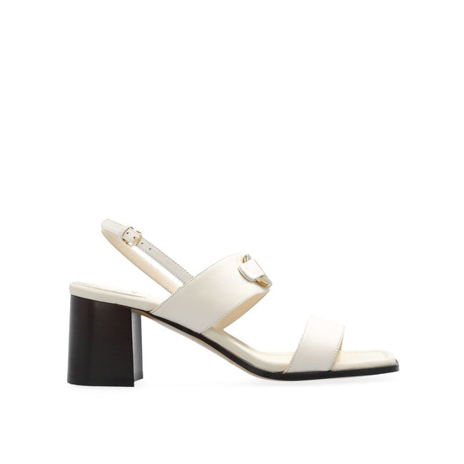 White Calfskin Strap-On SandalsDescription: – Composition: 100% calf leather – Inner: Leather – Insole: Leather – Sole: Leather – Square toe – Branded insole – Heel 7 cm – Ankle strap fastening – Decorative insert with an engraved logo – Made in Italy – G