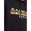 Black Cotton SweatshirtDescription: – Composition: 100% Cotton – Ribbed trims – Machine wash – Drawstring hood – Kangaroo pocket – Front logo detail – Gold-tone graphic print – Made in Italy – Gender: MEN – Size & Fit: True to size. Regular fit. Model’s M