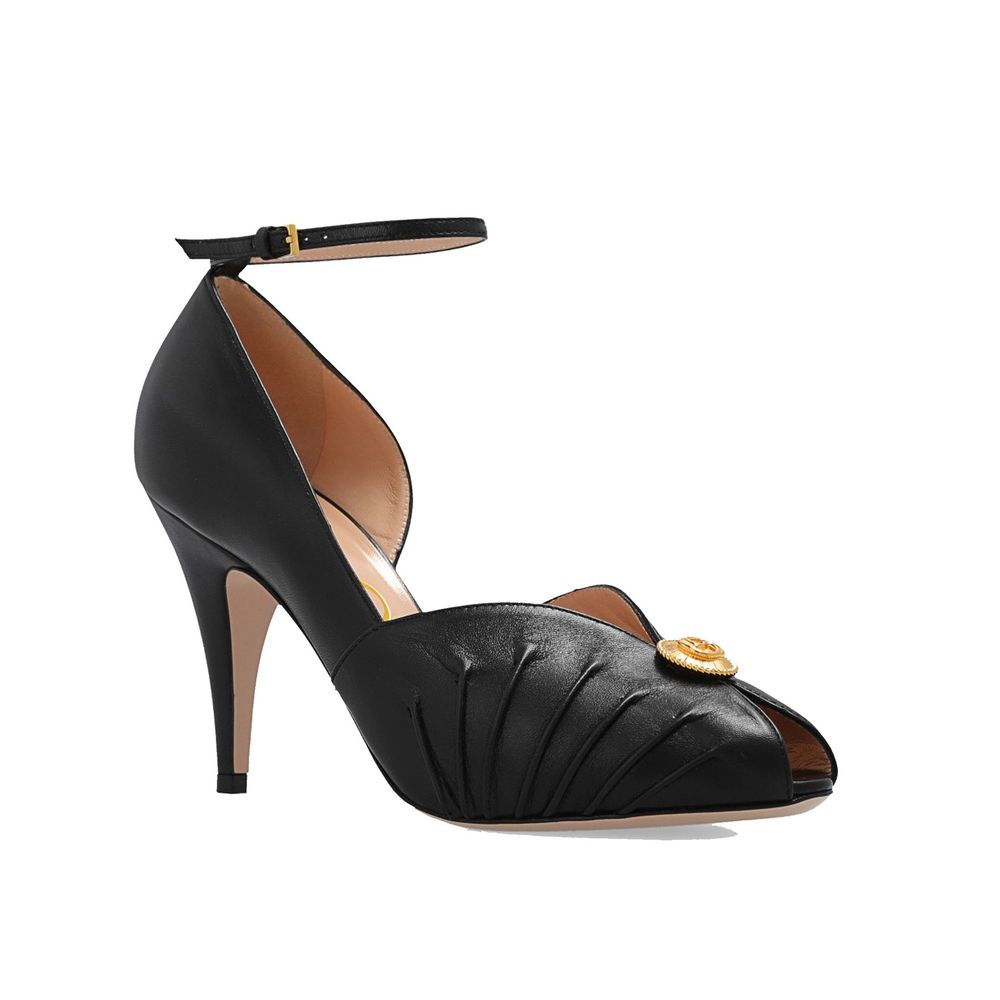 Black Leather High Heel PumpsDescription: – Composition: 100% Leather – Inner: 100% Leather – Insole: 100% Leather – Sole: 100% Leather – Heel: 10.0 cm / 25.4 in – branded insole – Open toe – Gold-colored metal application – ‘Interlocking G’ logo – Ankle