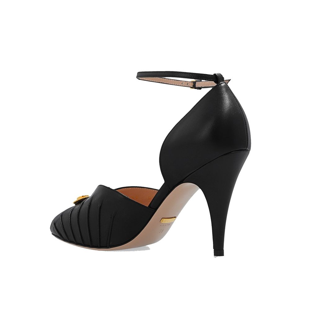 Black Leather High Heel PumpsDescription: – Composition: 100% Leather – Inner: 100% Leather – Insole: 100% Leather – Sole: 100% Leather – Heel: 10.0 cm / 25.4 in – branded insole – Open toe – Gold-colored metal application – ‘Interlocking G’ logo – Ankle