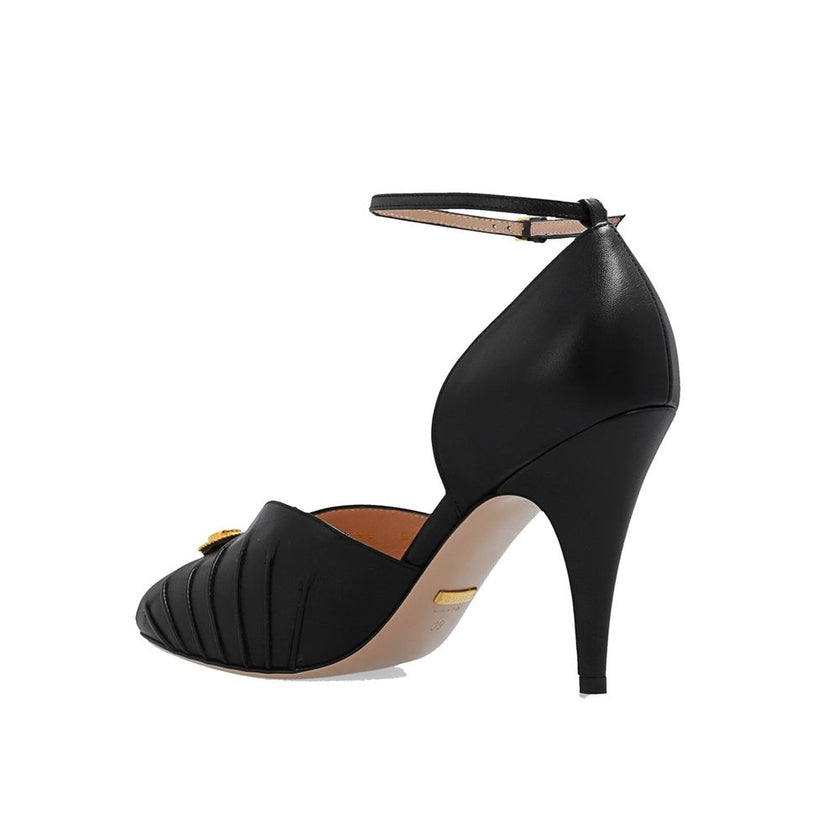 Black Leather High Heel PumpsDescription: – Composition: 100% Leather – Inner: 100% Leather – Insole: 100% Leather – Sole: 100% Leather – Heel: 10.0 cm / 25.4 in – branded insole – Open toe – Gold-colored metal application – ‘Interlocking G’ logo – Ankle