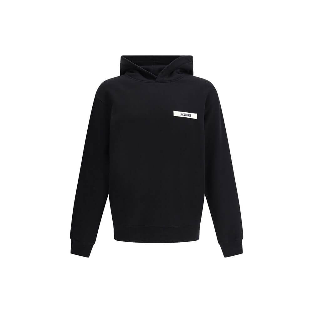 Black Cotton SweatshirtJacquemus’ Hooded Sweatshirt, made of soft cotton with a plush interior, offers snug comfort that is ideal for everyday wear. The clean design is embellished with an applied logo patch on the front, adding a distinctive and recogniz