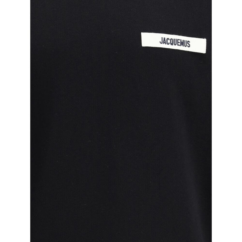 Black Cotton SweatshirtJacquemus’ Hooded Sweatshirt, made of soft cotton with a plush interior, offers snug comfort that is ideal for everyday wear. The clean design is embellished with an applied logo patch on the front, adding a distinctive and recogniz