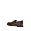Brown Calf Leather Bos Taurus Slip-On LoafersPrada’s leather Loafers are a mix of classic elegance and distinctive details. The slightly elongated round toe and leather block heel ensure comfort and style. The iconic enameled triangular plaque with the br