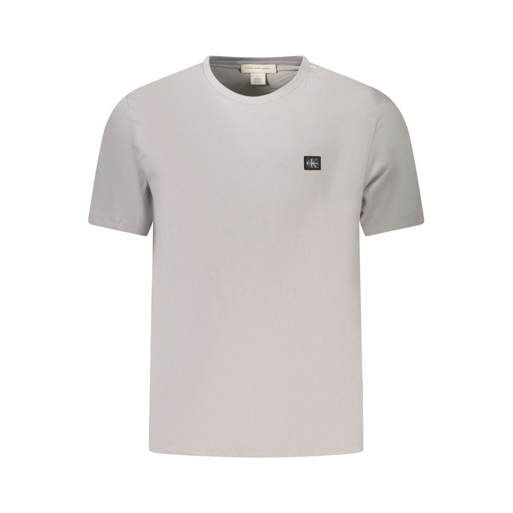 Gray Cotton Men T-ShirtElevate your casual wear with the unmistakable class of Calvin Klein. This short-sleeved gray T-shirt is the epitome of comfort meets style. Sporting a sleek crew neck and emblazoned with an iconic Calvin Klein logo, this tee is an
