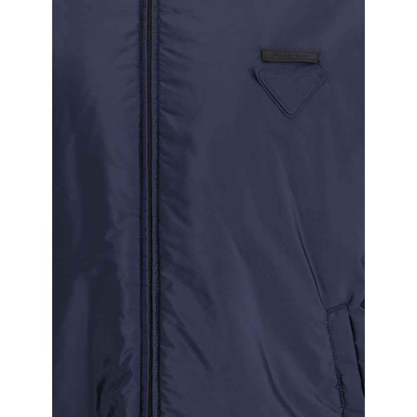 Blue Polyester Full-Length JacketNylon jacket with an all-over quilted design by Prada, perfect for tackling mid-season in style. Featuring an adjustable drawstring hood and front zipper closure, it has two handy side welt pockets and elastic cuffs for a