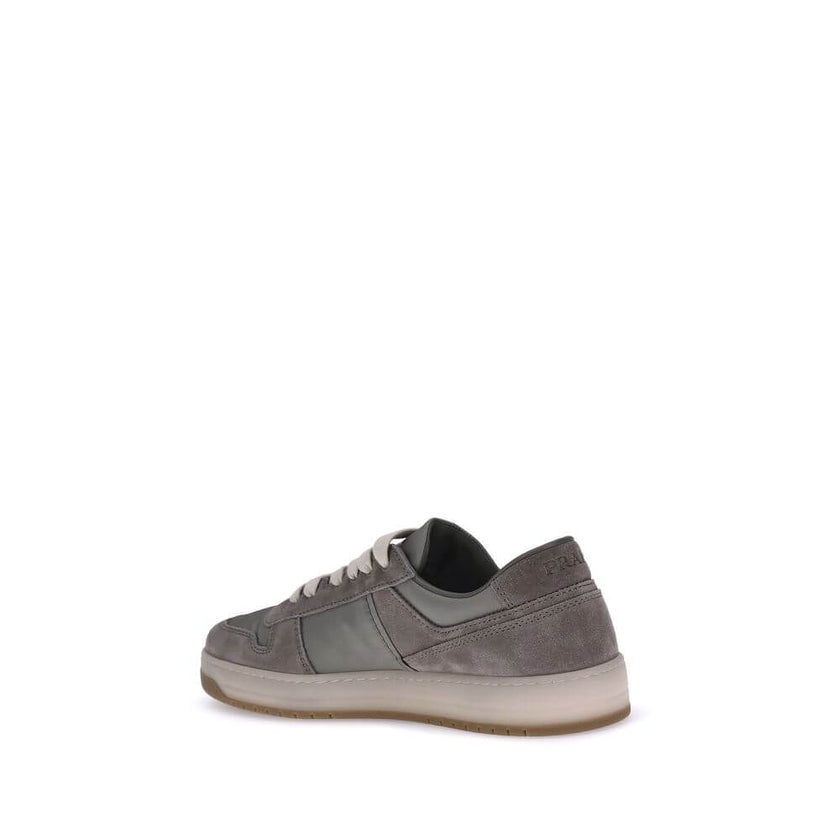 Gray Calf Leather Bos Taurus Low Top SneakersPrada’s suede sneakers are a model that combines discreet elegance and comfort. The soft suede leather gives a sophisticated texture, perfect for a casual yet refined look. The lace-up top closure ensures an ad