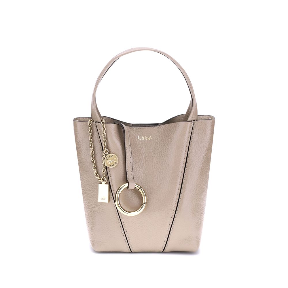 Beige Calf Leather Bos Taurus Shoulder BagThe Spin Shoulder Bag by Chloé, crafted by shiny grained leather, features an elegant design with two flat top handles and an adjustable shoulder strap. The closure is secured by a magnetic button, while the detai