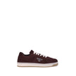 Bordeaux Calf Leather Bos Taurus Low Top SneakersPrada’s suede sneakers are a model that combines discreet elegance and comfort. The soft suede leather gives a sophisticated texture, perfect for a casual yet refined look. The lace-up top closure ensures a
