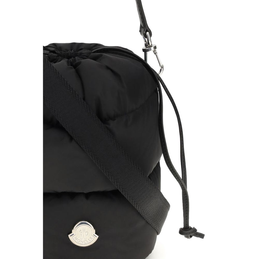 Black Polyester Backet BagMoncler’s Caradoc Bucket Bag is made of water-repellent nylon, with an inner lining of the same material for extra protection. Padded with down, it offers a practical drawstring closure. The leather shoulder strap is adjustable a