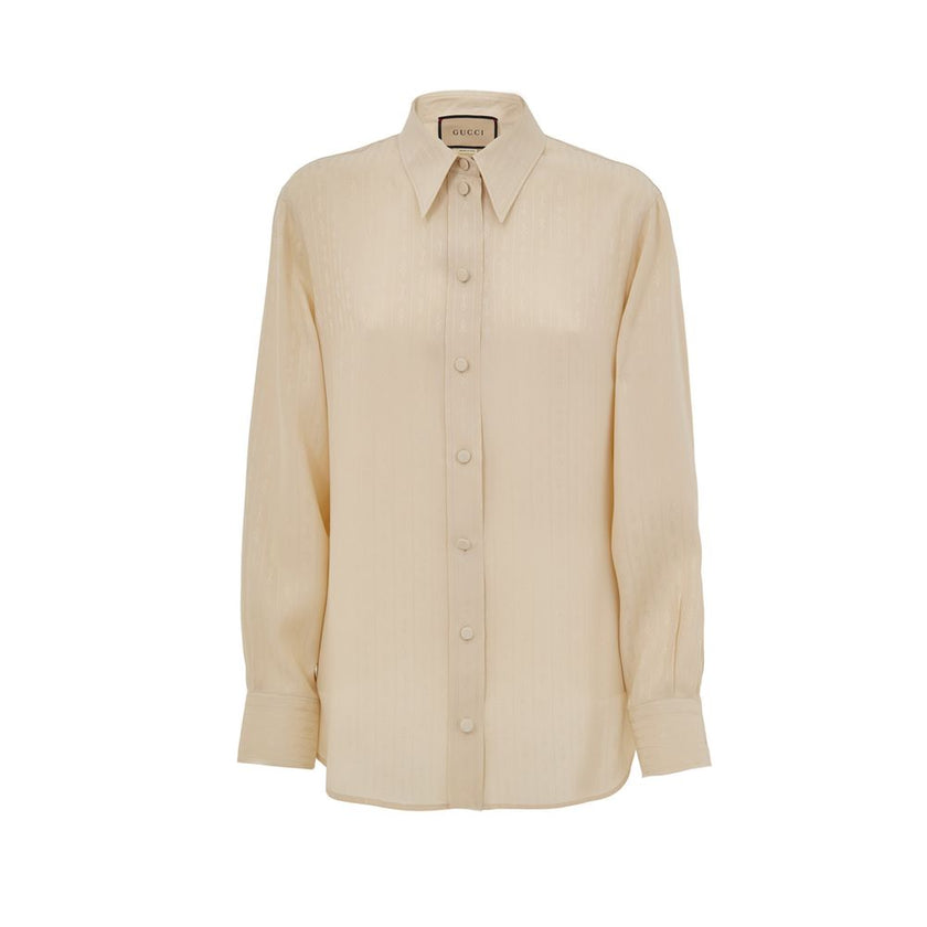 Beige Silk Pattern ShirtBeige Silk Shirt Horsebit Print Gucci. Classic collar, front fastening with fabric-covered buttons. Tone-on-tone stripes with allover horsebit print, rounded at the bottom. Composition: 100% Silk Internal SKU: 25GIU203 Brand SKU: 7