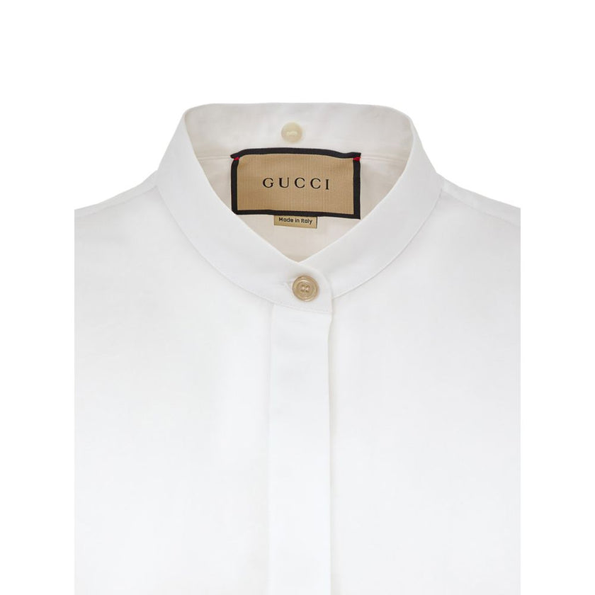 White Cotton Dress ShirtWhite Shirt with Removable Jewel Collar Gucci. Front fastening with covered buttons, long sleeves, removable classic collar covered with decorated tulle and crystals, Korean collar. Regular fit. Composition: 100% Cotton Internal SK