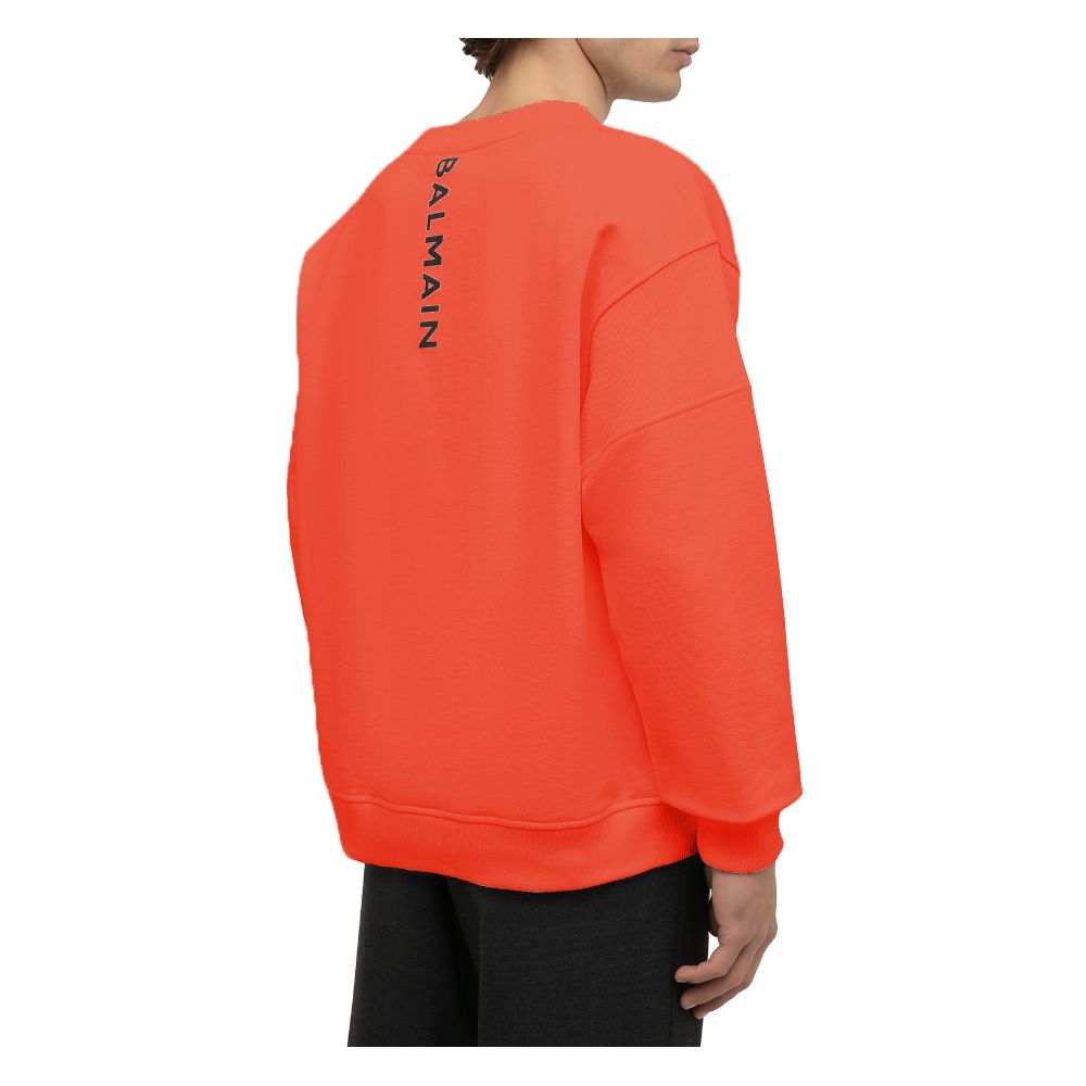 Orange Cotton Men SweaterElevate your style quotient with the Balmain cotton sweatshirt, where comfort meets high fashion. This bold orange piece showcases an audacious logo print on the back complemented by a striking rubber logo on the front, encapsulat