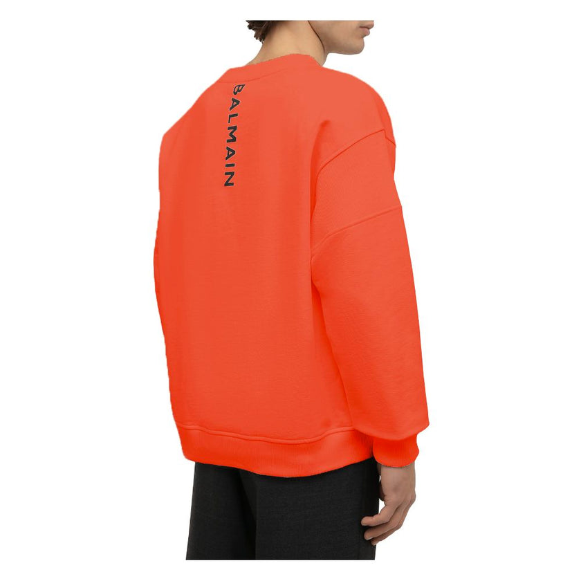 Orange Cotton Men SweaterElevate your style quotient with the Balmain cotton sweatshirt, where comfort meets high fashion. This bold orange piece showcases an audacious logo print on the back complemented by a striking rubber logo on the front, encapsulat