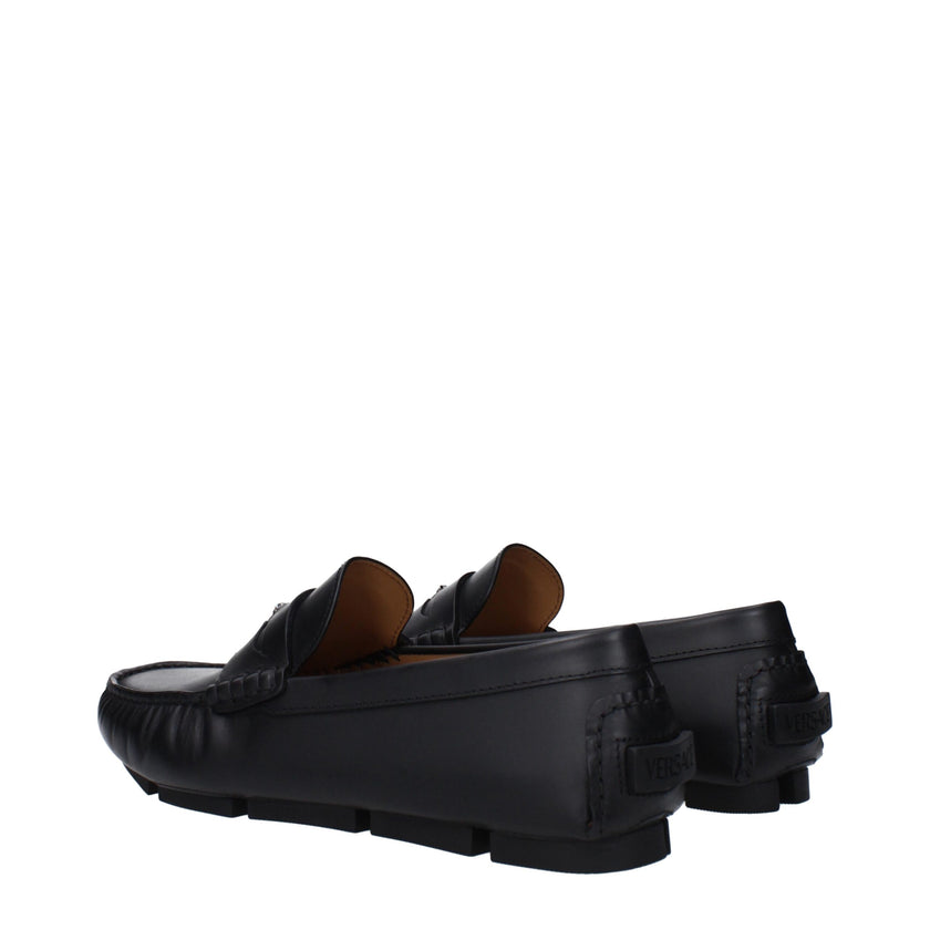 Black Leather Slip-On LoafersDescription: The product with MPN 10139601A006931B00E and code F82958 leather in black is a loafers designed by Versace. It has features like back logo, front detail. Additional Info: Color details: Gold Style: Stylish Materia
