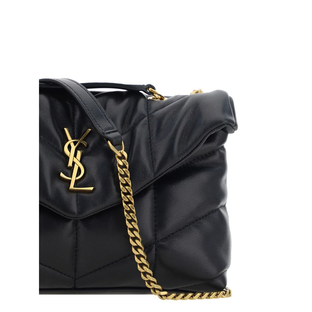Black Lamb Ovis Aries Aries Shoulder BagThe Puffer Toy Shoulder Bag by Saint Laurent is a compact and luxurious accessory perfect for completing elegant looks with a contemporary twist. Made of soft lambskin leather, it features a padded design with all-o