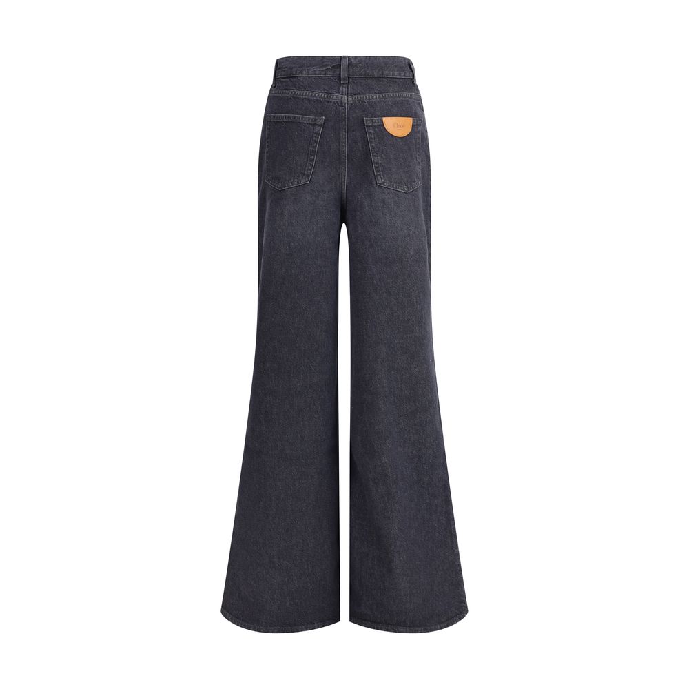 Black Cotton Flared JeansPure cotton five-pocket Jeans by Chloé feature a front zip-and-button closure. The mid-rise style has belt loops at the waist and features a logo leather patch applied at the back. An essential garment with a versatile design, ide