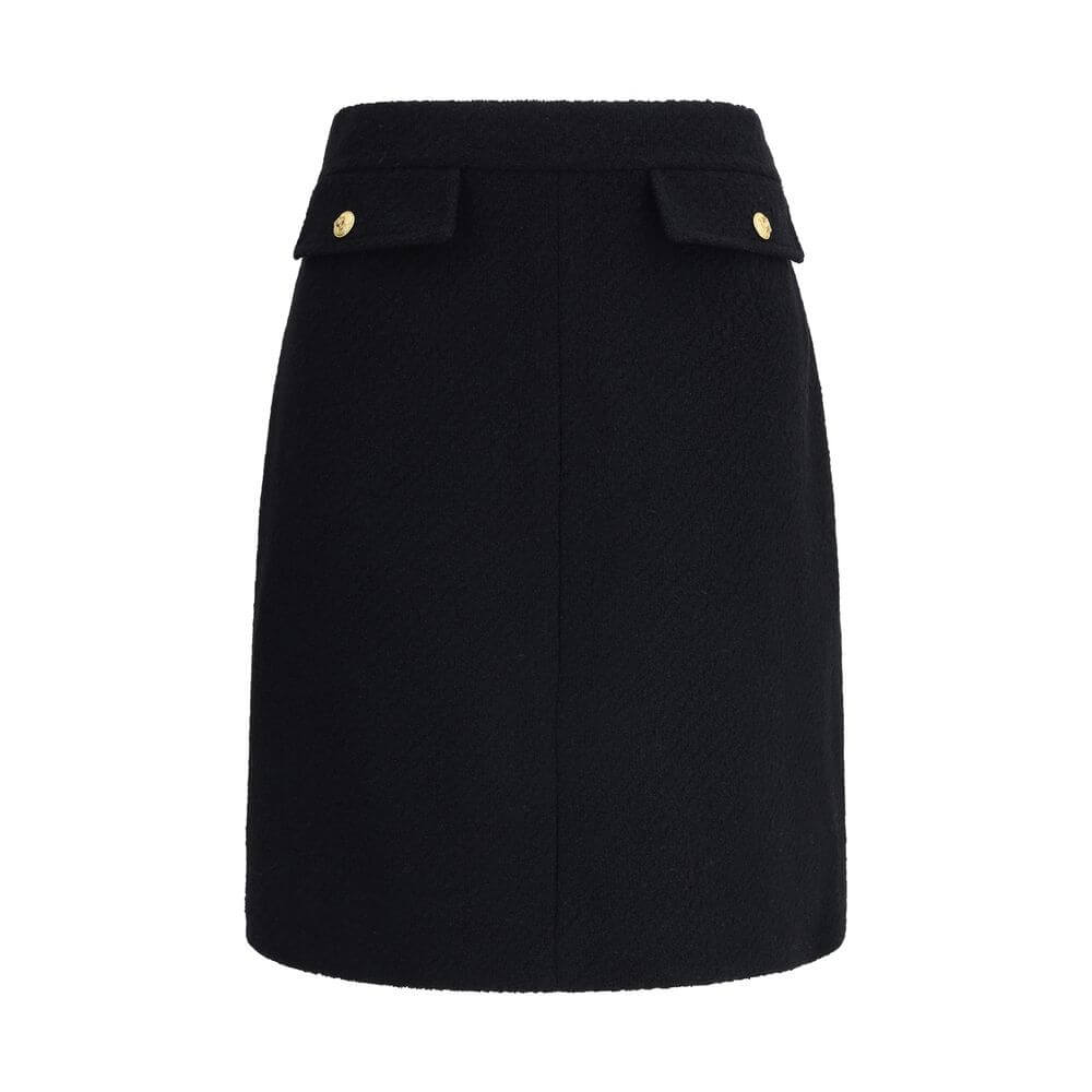 Black Wool Midi SkirtChloé’s Bouclé wool midi Skirt is a sleek, structured piece designed to hit the knee. Crafted from premium bouclé wool, it features front flap pockets accented with gold-tone buttons. The side zip and hook fastening on the left hip en