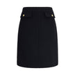 Black Wool Midi SkirtChloé’s Bouclé wool midi Skirt is a sleek, structured piece designed to hit the knee. Crafted from premium bouclé wool, it features front flap pockets accented with gold-tone buttons. The side zip and hook fastening on the left hip en