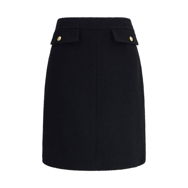 Black Wool Midi SkirtChloé’s Bouclé wool midi Skirt is a sleek, structured piece designed to hit the knee. Crafted from premium bouclé wool, it features front flap pockets accented with gold-tone buttons. The side zip and hook fastening on the left hip en