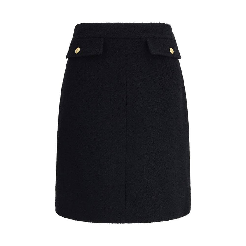 Black Wool Midi SkirtChloé’s Bouclé wool midi Skirt is a sleek, structured piece designed to hit the knee. Crafted from premium bouclé wool, it features front flap pockets accented with gold-tone buttons. The side zip and hook fastening on the left hip en