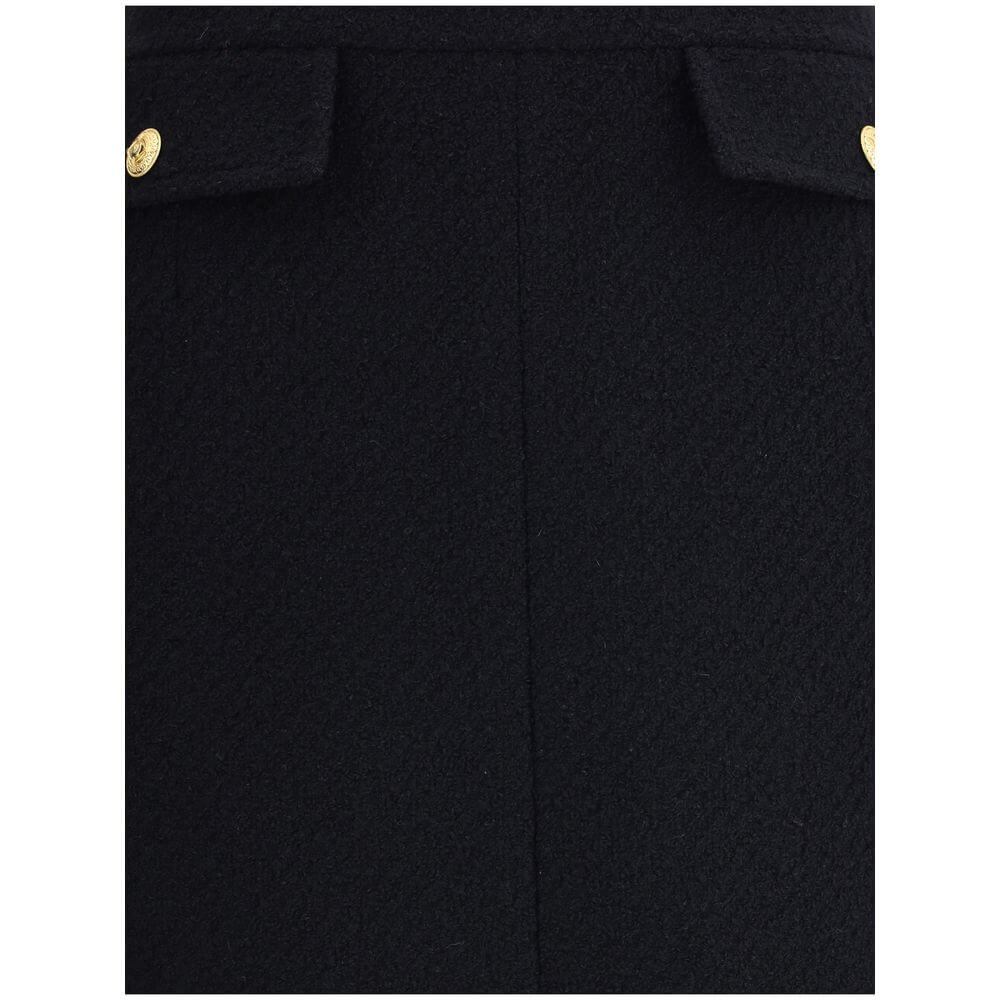 Black Wool Midi SkirtChloé’s Bouclé wool midi Skirt is a sleek, structured piece designed to hit the knee. Crafted from premium bouclé wool, it features front flap pockets accented with gold-tone buttons. The side zip and hook fastening on the left hip en